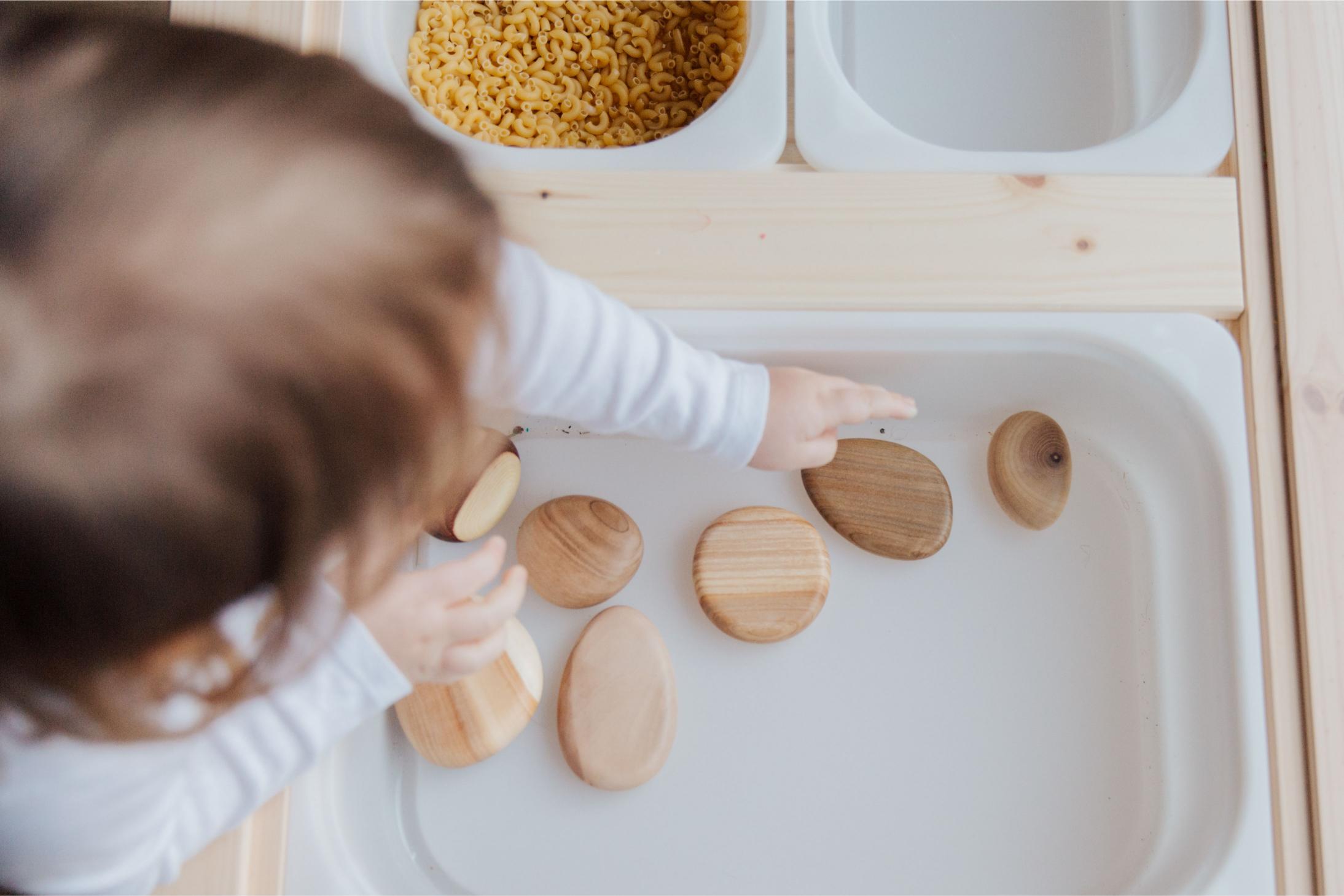 A child exploring natural wooden materials
